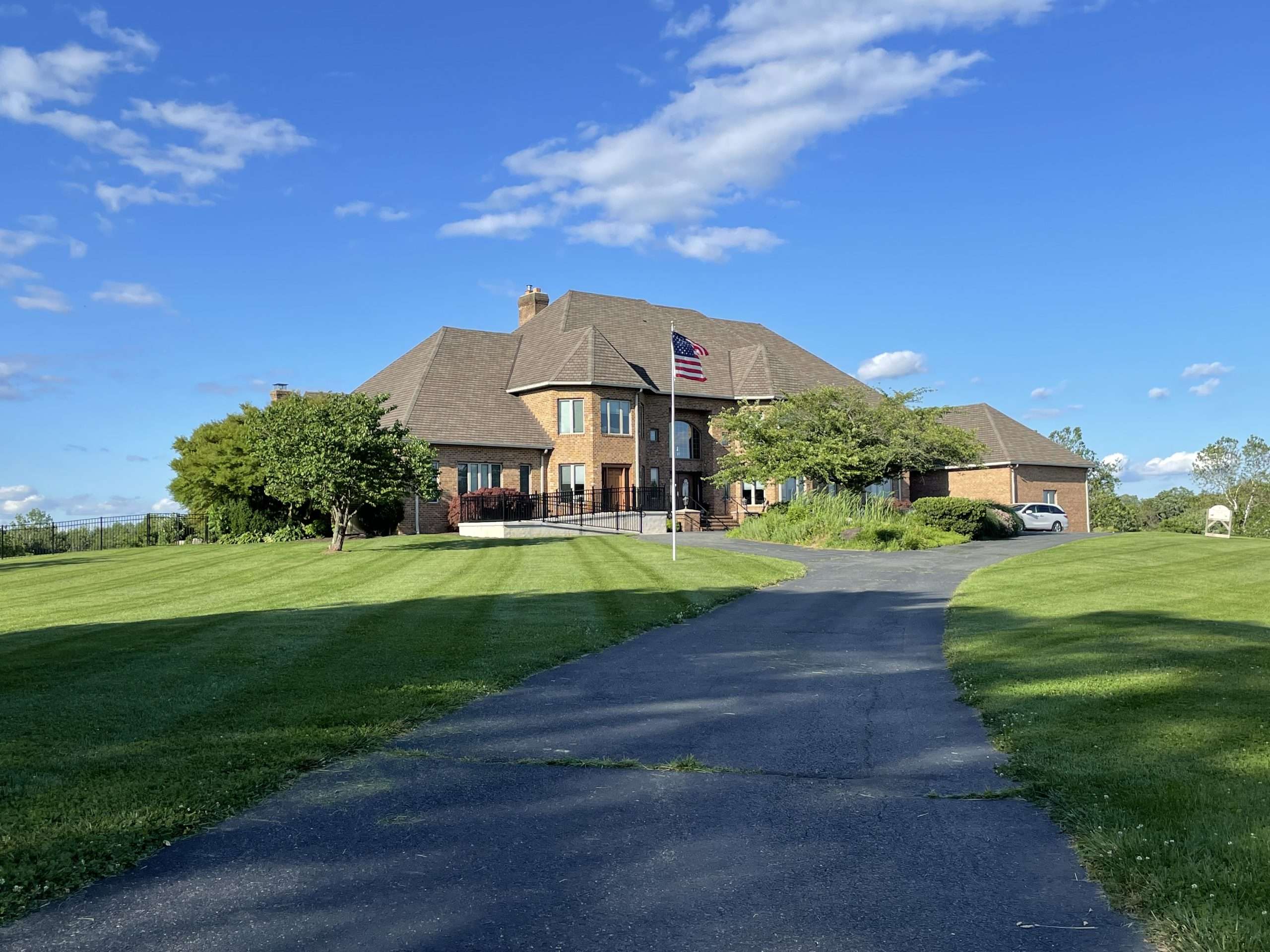 A beautiful residential lawn cared for with Lawn Life Turf Services' fertilization, aeration, overseeding, and lawn restoration services.